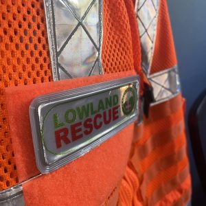 Lowland Rescue encapsulated badge on a orange search vest